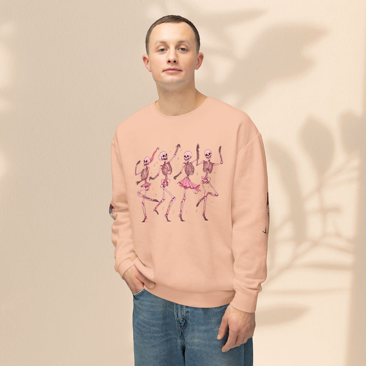 Sea Dragon Dreams unisex peach crewneck sweatshirt featuring a graphic of four dancing skeletons in pink.