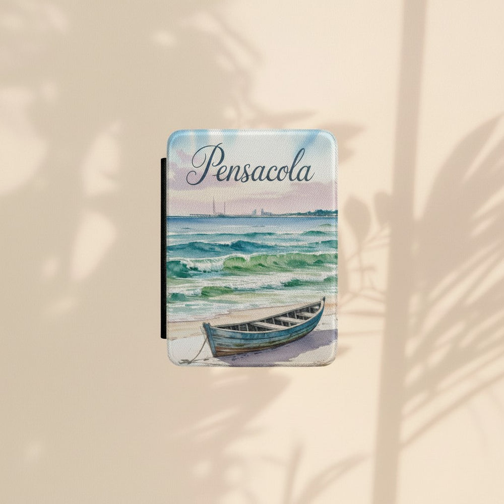 Sea Dragon Dreams Kindle Paperwhite case featuring a watercolor Pensacola Beach scene with a boat on the sand.