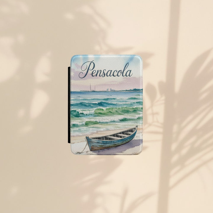 Sea Dragon Dreams Kindle Paperwhite case featuring a watercolor Pensacola Beach scene with a boat on the sand.
