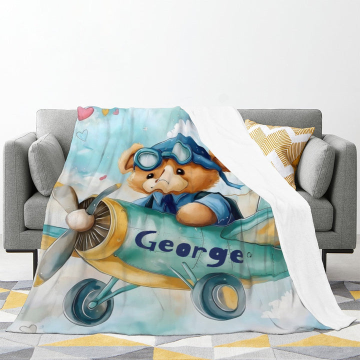 Sea Dragon Dreams personalised fleece blanket featuring a teddy bear pilot in a plane with the name George printed