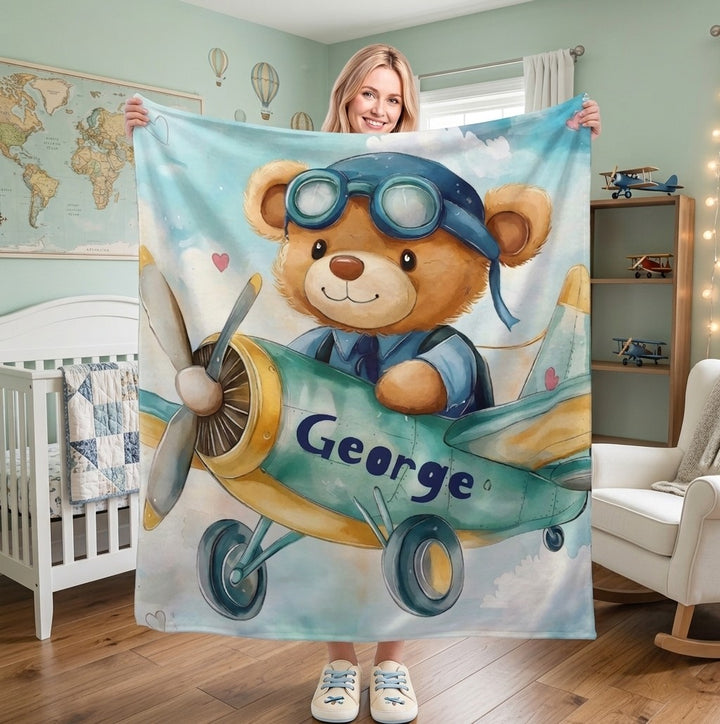 Sea Dragon Dreams personalised fleece blanket featuring a teddy bear pilot in a plane, customised with the name George.