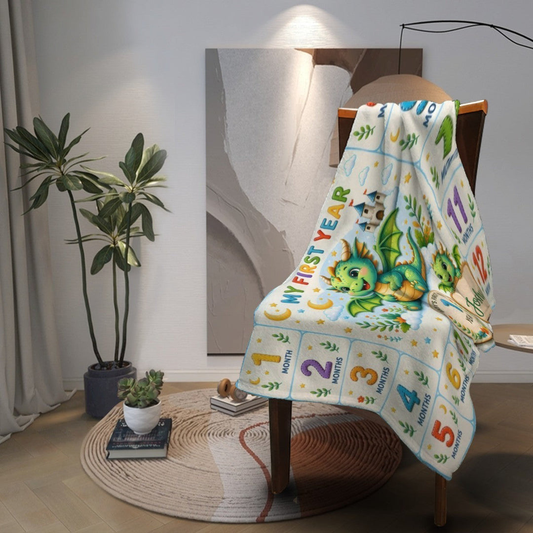 Sea Dragon Dreams personalized baby milestone blanket with a whimsical dragon design draped over a wooden chair.