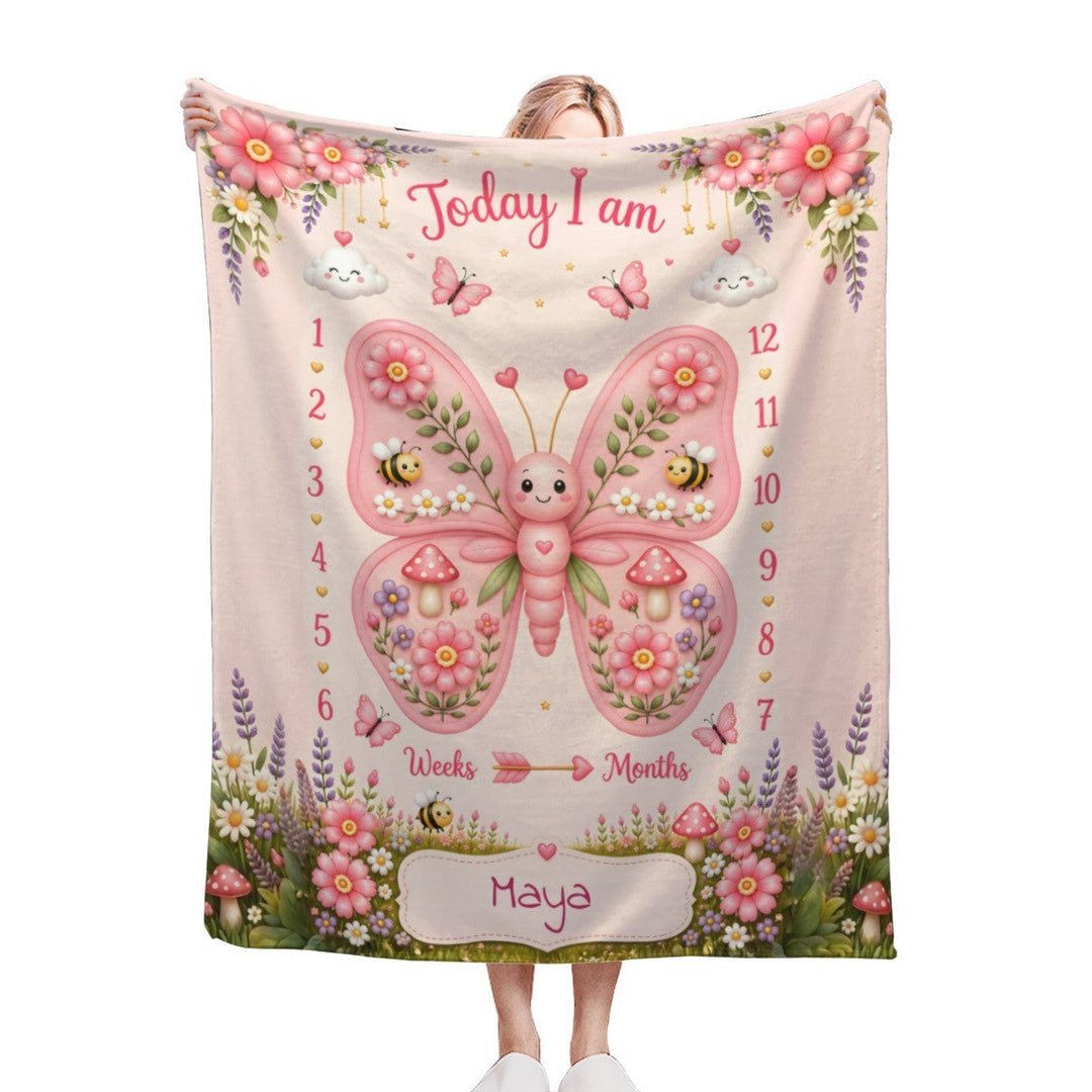 Sea Dragon Dreams personalized baby milestone blanket with a pink butterfly, floral garden, and custom name Maya.
