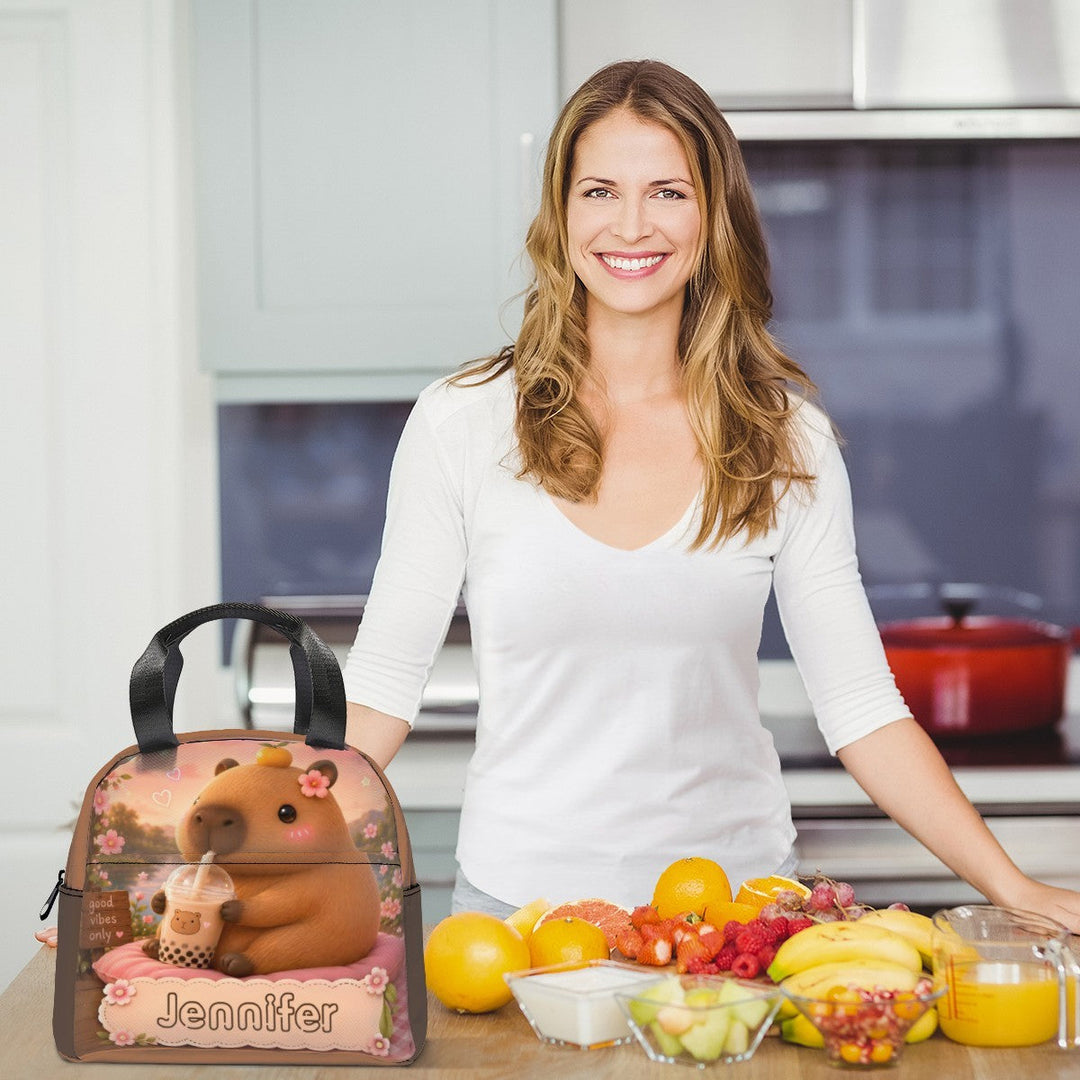 Sea Dragon Dreams personalized capybara boba tea lunch bag with custom name on a kitchen counter with fresh fruit
