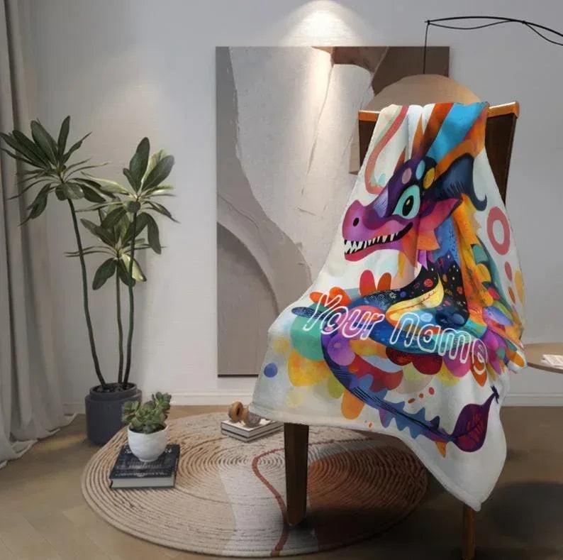 Sea Dragon Dreams personalized flannel fleece blanket with a colorful dragon illustration draped over a wooden chair.