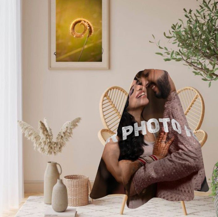 Sea Dragon Dreams personalized round photo blanket featuring a couple, draped over a rattan chair in a cozy room.