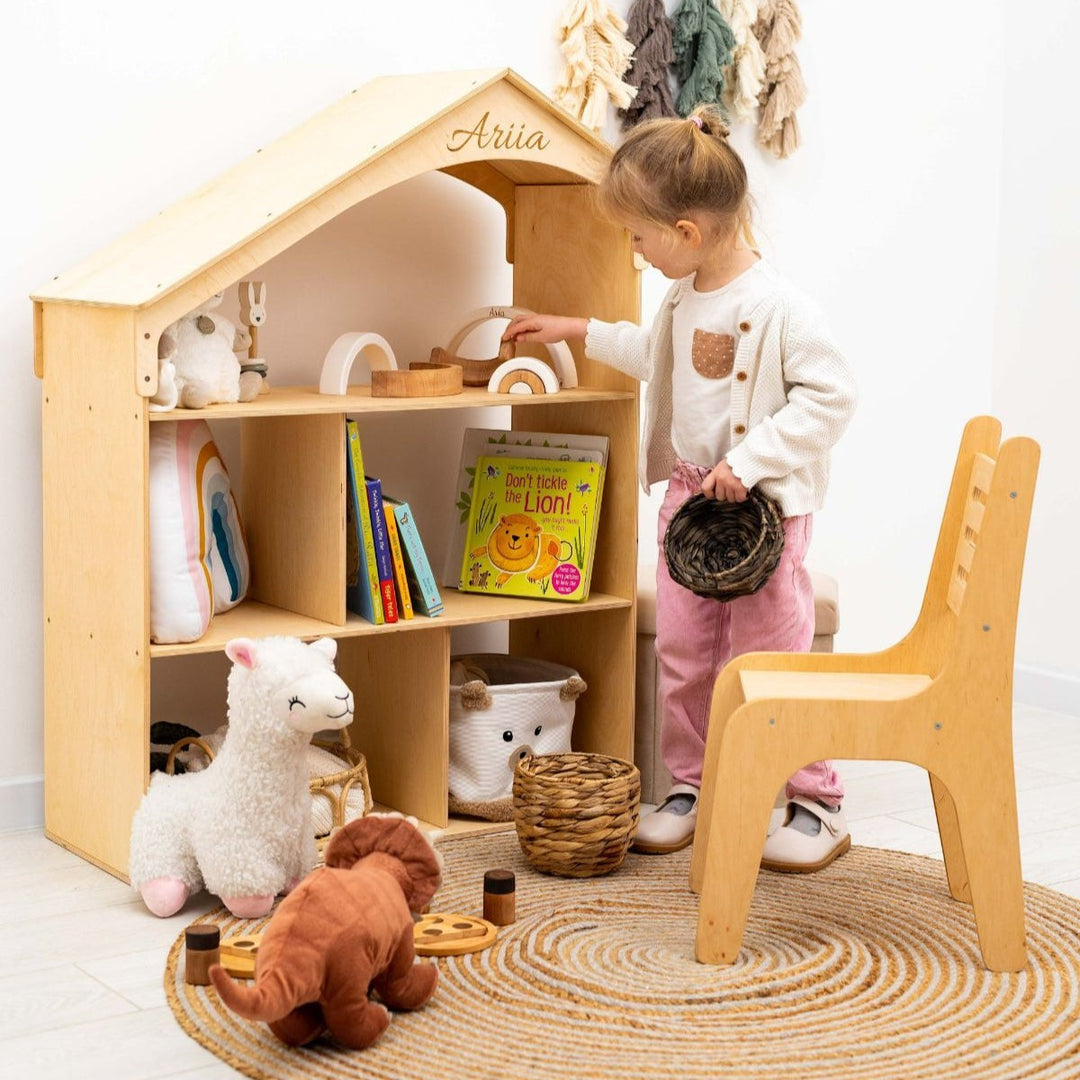 Sea Dragon Dreams wooden dollhouse bookcase with personalized name engraving, filled with books and toys in a nursery.