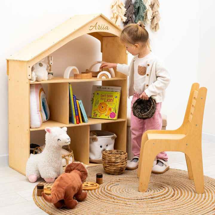 Sea Dragon Dreams wooden dollhouse bookcase with personalized name engraving, filled with books and toys in a nursery.