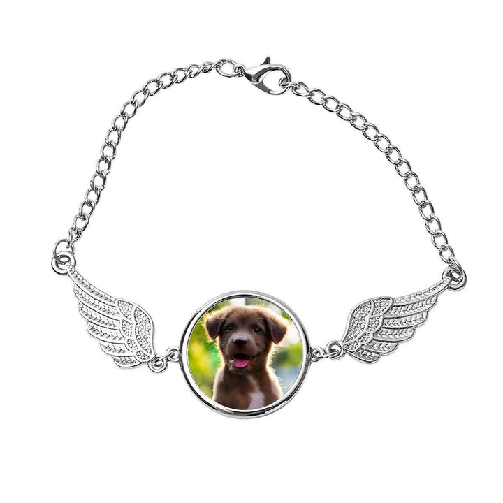 Sea Dragon Dreams silver pet memorial bracelet featuring a circular photo charm flanked by delicate angel wings.
