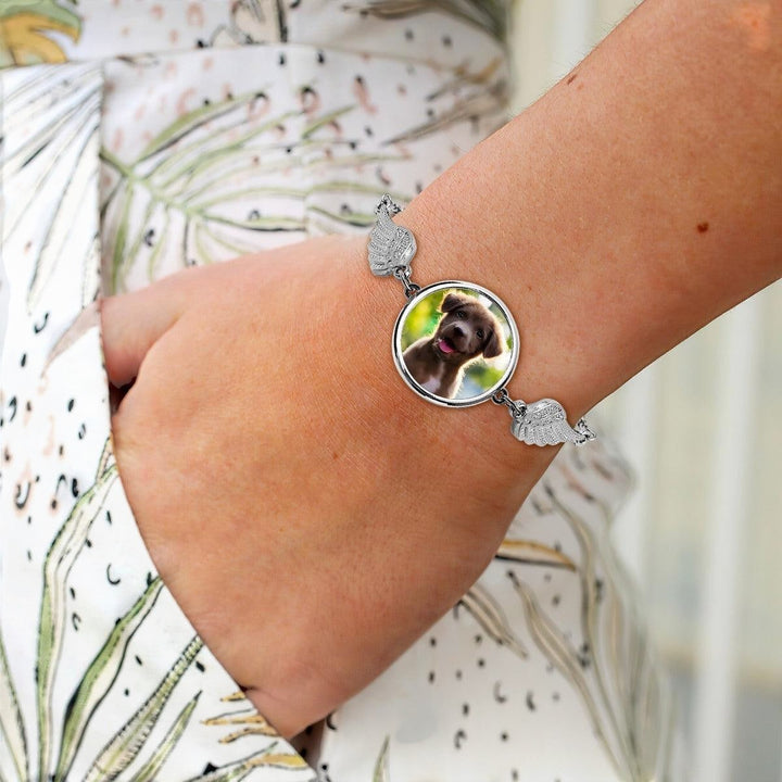 Sea Dragon Dreams silver memorial bracelet featuring a custom pet photo charm flanked by delicate angel wings