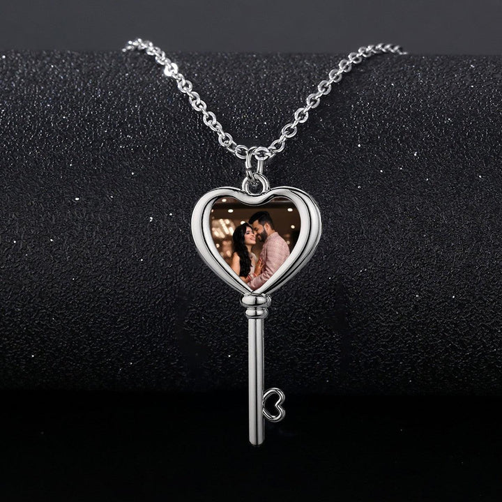 Sea Dragon Dreams silver heart and key pendant necklace featuring a custom photo of a couple inside the heart charm.