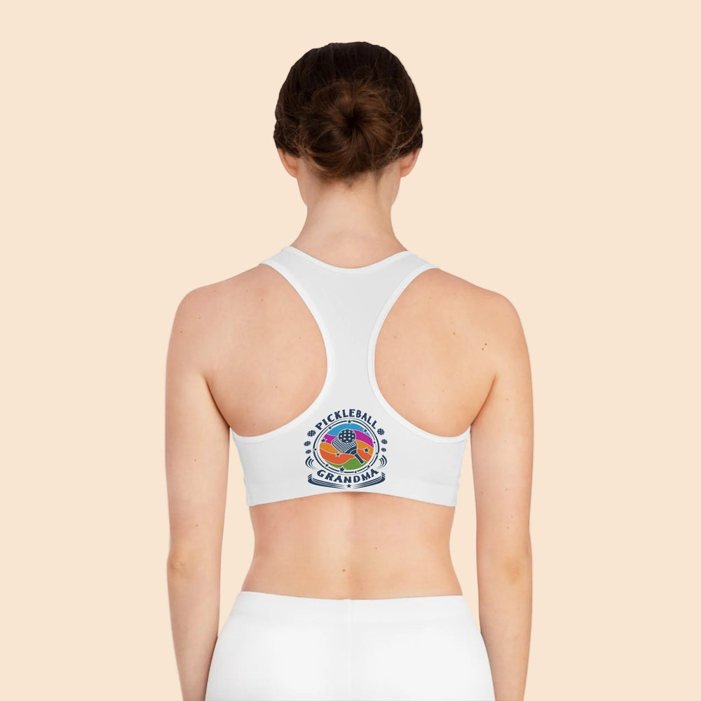 Sea Dragon Dreams white racerback sports bra with Pickleball Grandma logo on the back, worn by a woman.
