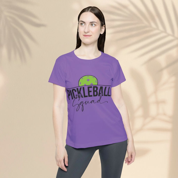 Sea Dragon Dreams purple moisture-wicking sports jersey with Pickleball Squad graphic worn by a woman.