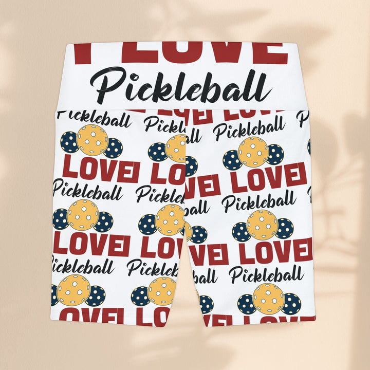 Sea Dragon Dreams women's workout shorts featuring a white base with a red and yellow pickleball-themed pattern.