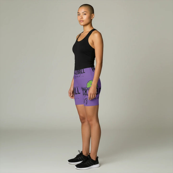 Sea Dragon Dreams purple workout shorts with Pickleball Squad graphic worn by a model in profile view.