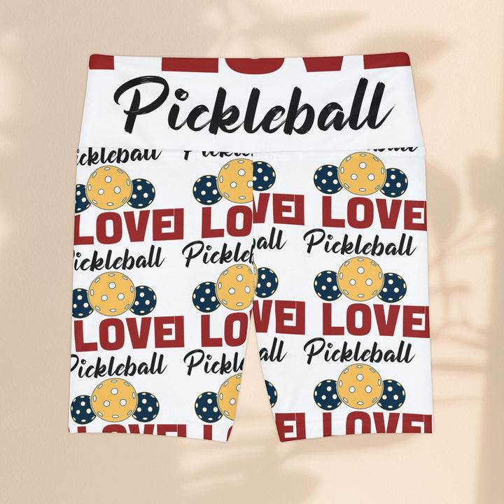 Sea Dragon Dreams women's workout shorts featuring a white base with a red and yellow pickleball-themed pattern.