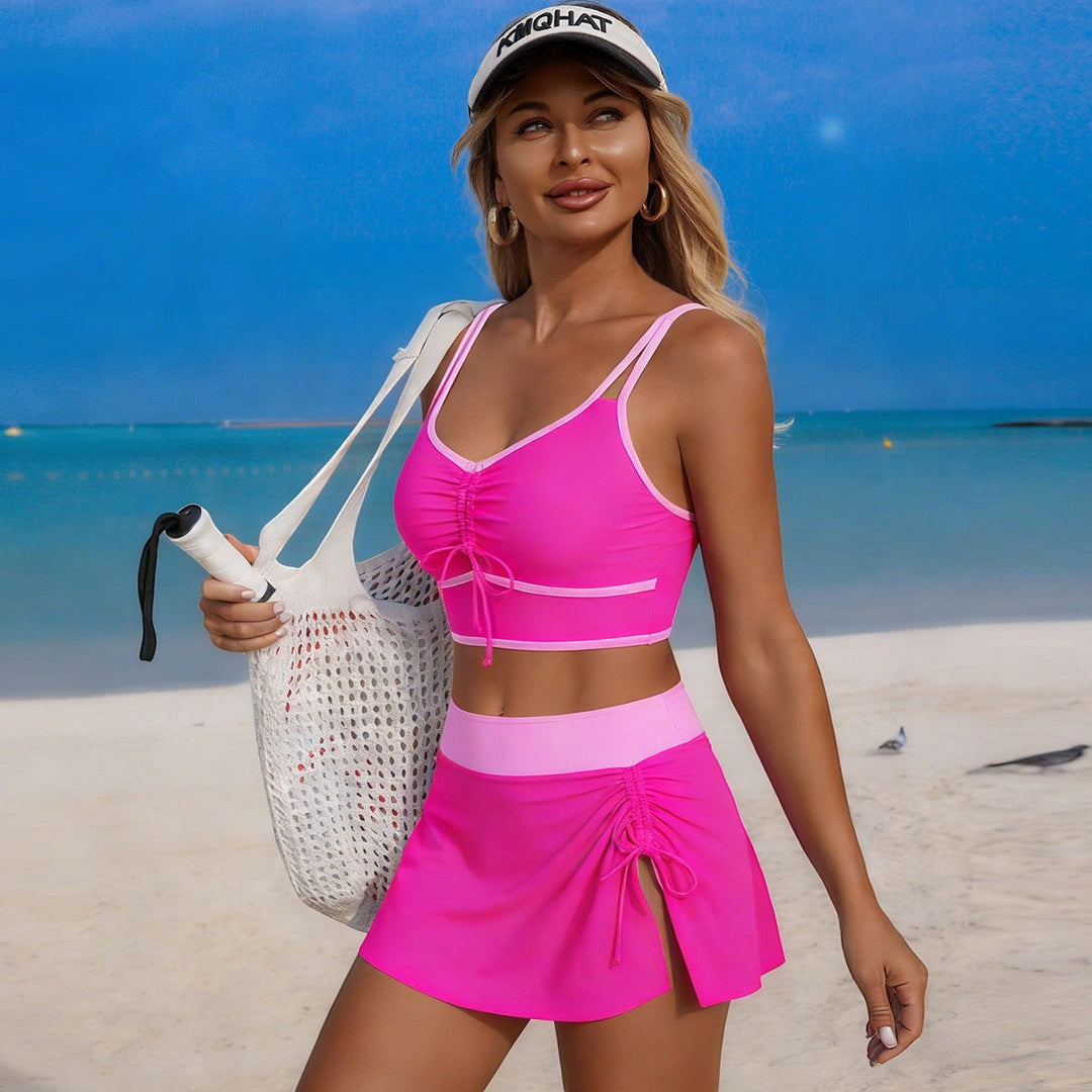 Sea Dragon Dreams hot pink athletic bikini set with drawstring skirt and top on a woman at the beach