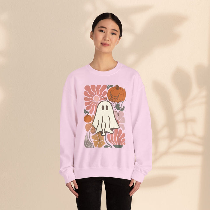Sea Dragon Dreams light pink crewneck sweatshirt featuring a retro ghost and pumpkin graphic print on a model.