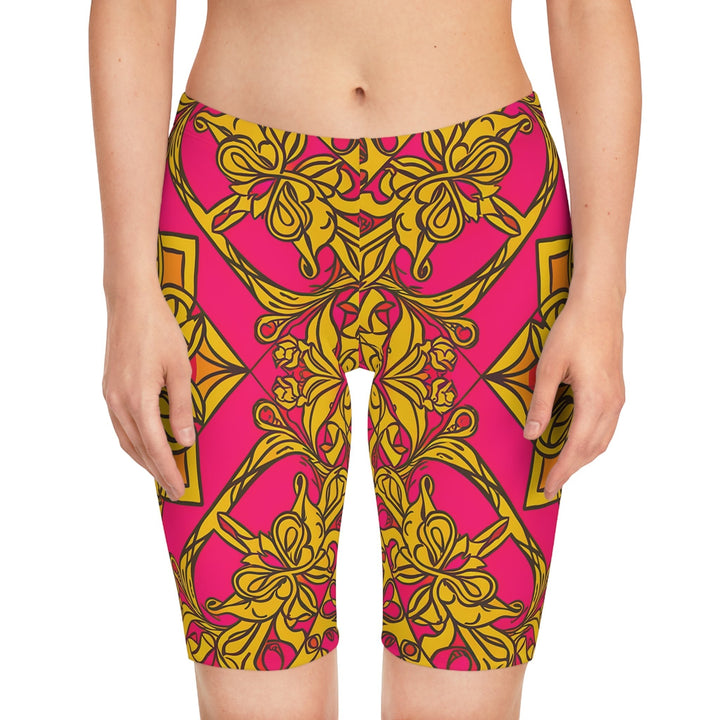 Sea Dragon Dreams women's bike shorts featuring a vibrant pink and gold symmetrical floral pattern in stretchy fabric.