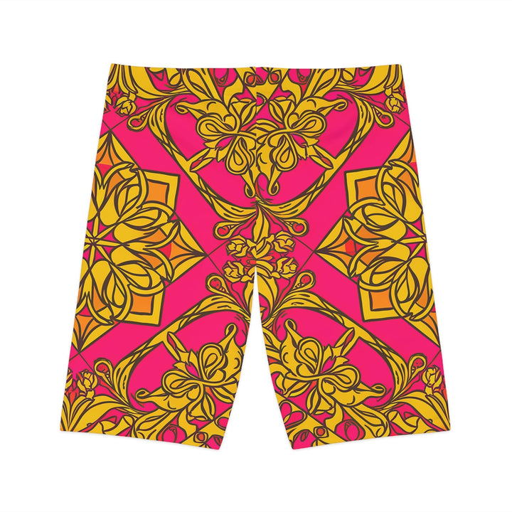 Sea Dragon Dreams women's bike shorts featuring a vibrant pink and gold symmetrical floral pattern in polyester blend