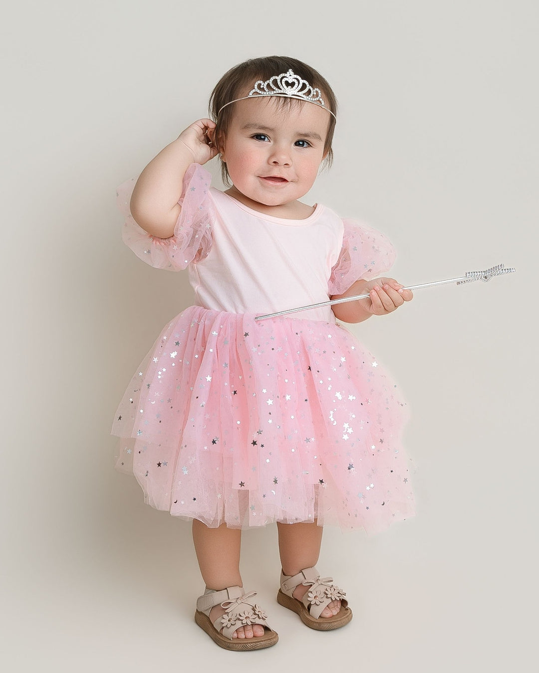 Sea Dragon Dreams toddler girl wearing a pink Good Witch costume with puff sleeves and a star-patterned tulle skirt.
