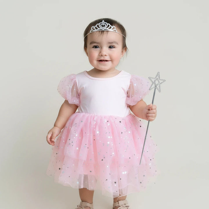 Sea Dragon Dreams toddler girl wearing a pink Good Witch costume with puff sleeves, tulle skirt, and star accents.