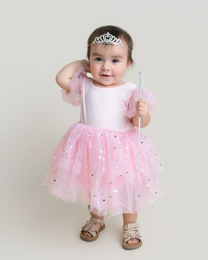 Sea Dragon Dreams toddler girl wearing a pink Good Witch costume with puff sleeves and a star-patterned tulle skirt.