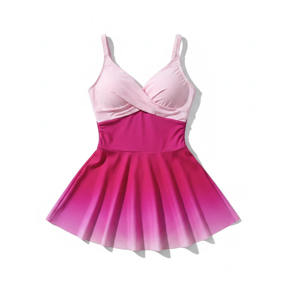 Sea Dragon Dreams pink gradient one-piece swim dress with a flattering skirted silhouette and cross-front bodice.