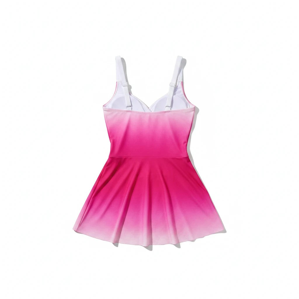 Sea Dragon Dreams pink gradient one-piece swim dress with a flattering skirted silhouette and white adjustable straps.