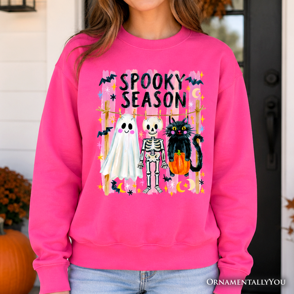 Sea Dragon Dreams hot pink sweatshirt featuring a colorful Spooky Season ghost, skeleton, and black cat graphic.