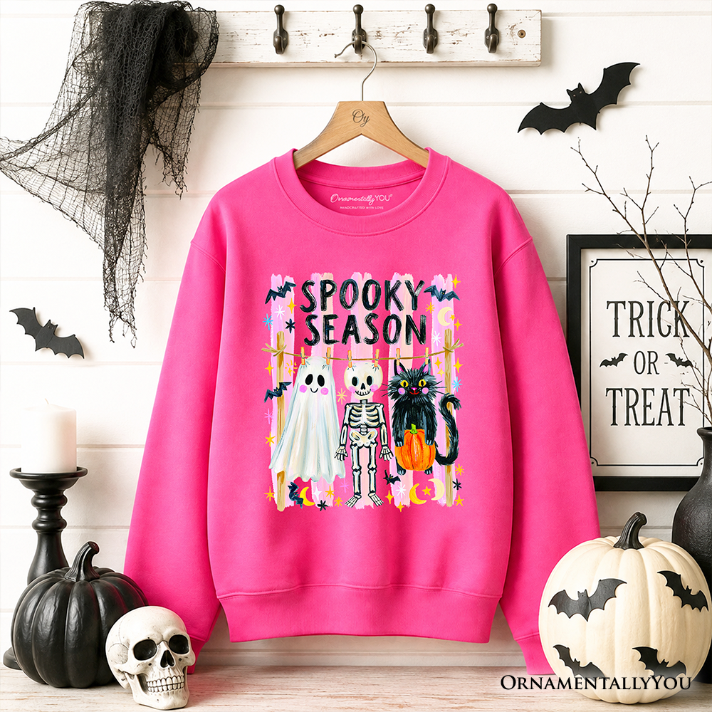 Sea Dragon Dreams bright pink Halloween sweatshirt featuring a ghost, skeleton, and black cat with Spooky Season text.