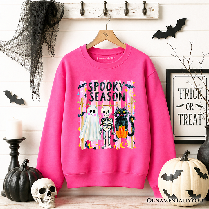 Sea Dragon Dreams bright pink Halloween sweatshirt featuring a ghost, skeleton, and black cat with Spooky Season text.
