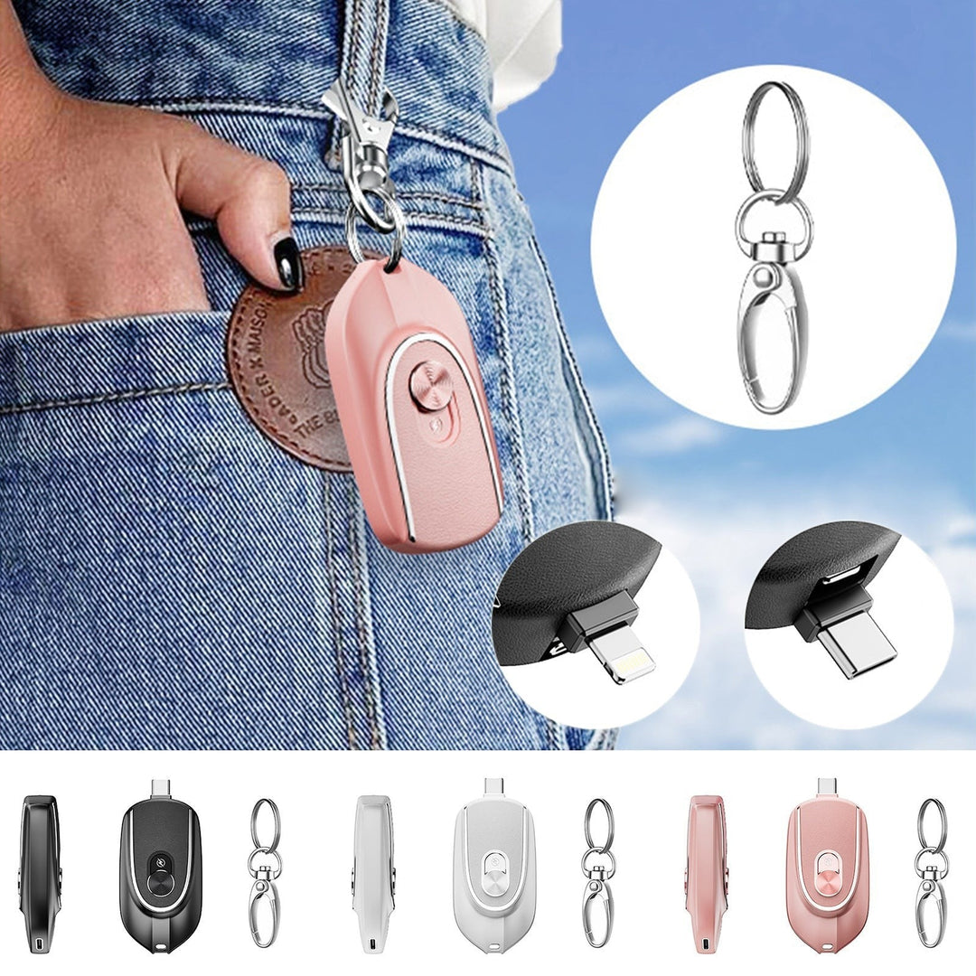 Sea Dragon Dreams pink mini keychain power bank with retractable USB-C and Lightning connectors clipped to jeans.