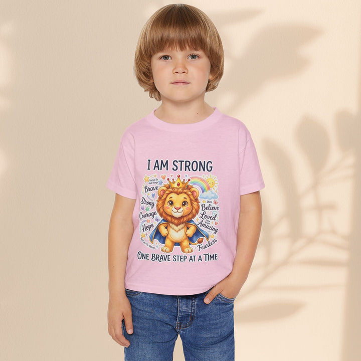 Sea Dragon Dreams toddler t-shirt in light pink cotton featuring a courageous lion graphic and I Am Strong text.