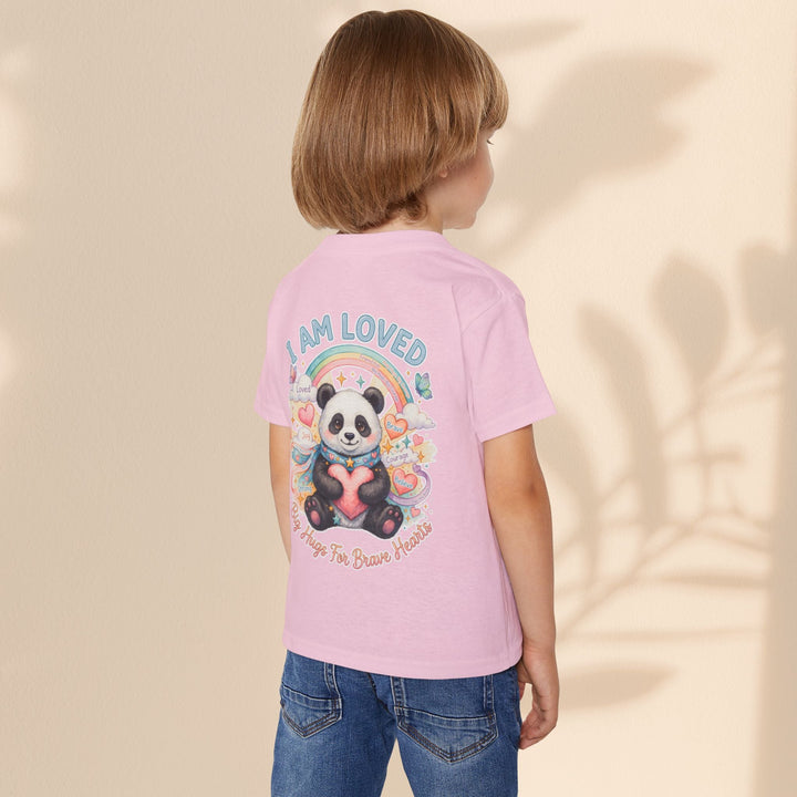 Sea Dragon Dreams toddler t-shirt in light pink cotton featuring a Huggie Panda graphic with a rainbow and heart.