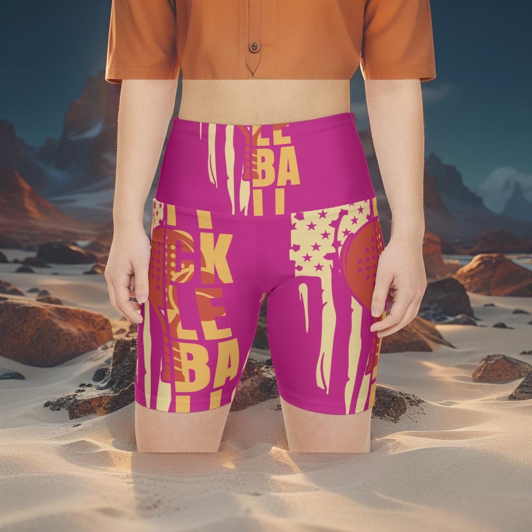 Sea Dragon Dreams pink polyester workout shorts with pickleball graphic, worn by a model in a desert landscape.