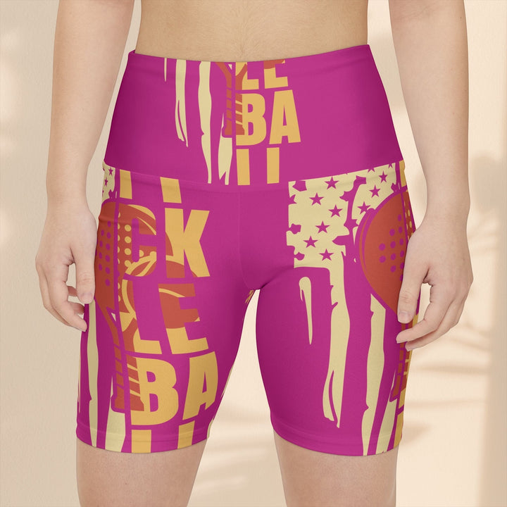 Sea Dragon Dreams pink pickleball workout shorts with yellow graphic print and elastic waistband on a model