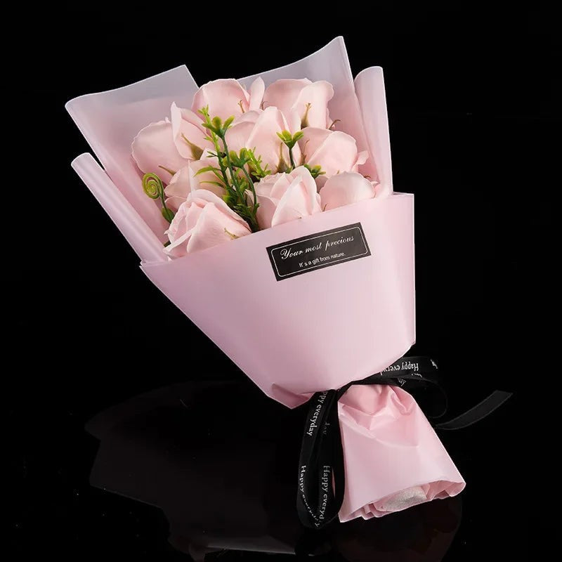 Sea Dragon Dreams bouquet of nine light pink artificial soap roses wrapped in matching paper with a black ribbon.