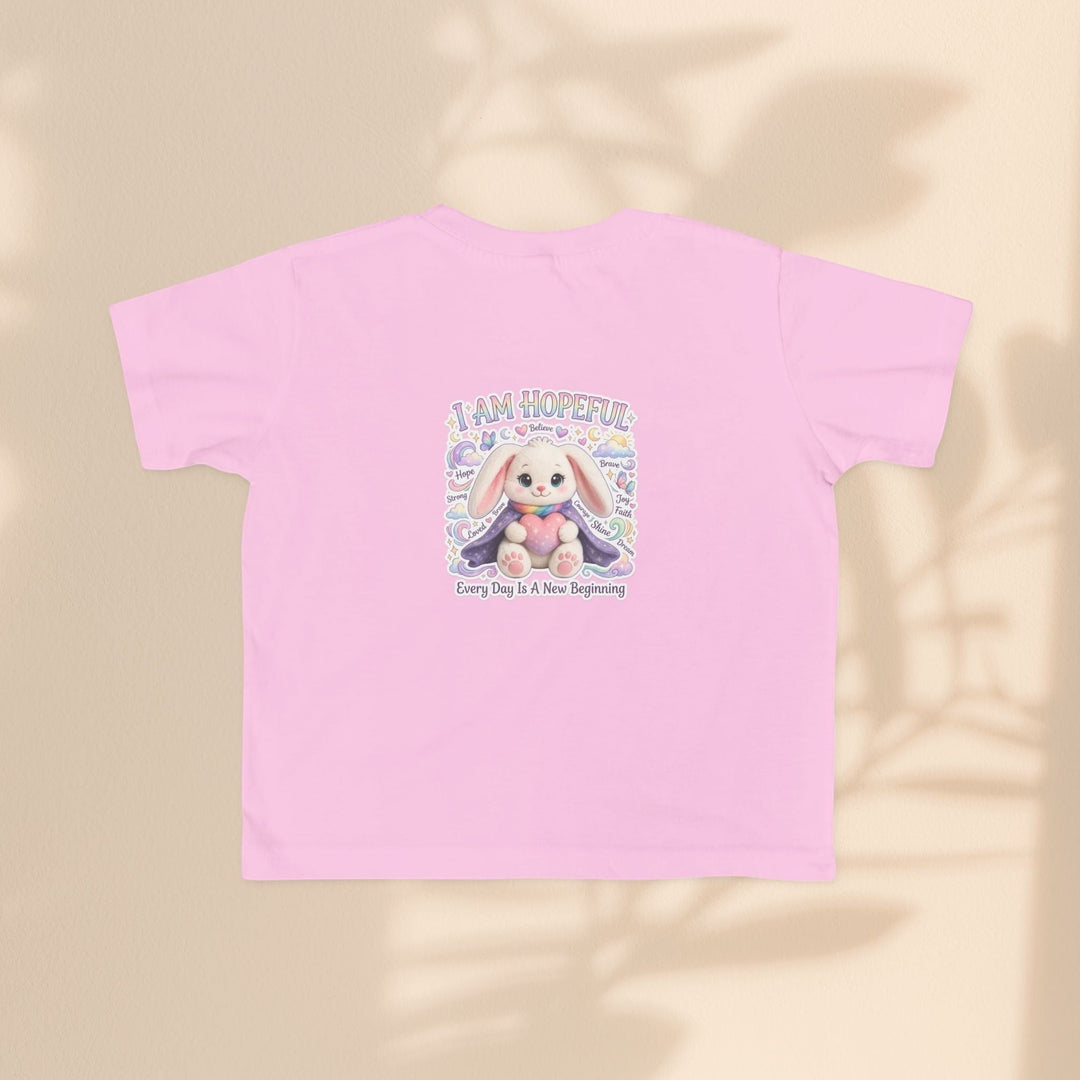 Sea Dragon Dreams toddler tee in light pink cotton featuring the Brave Buddies Hope Bunny graphic and I Am Hopeful text.