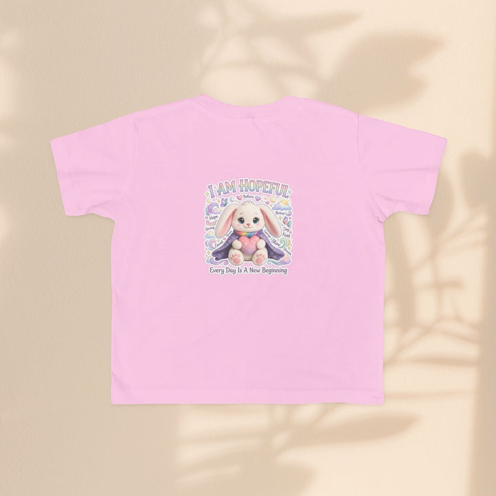 Sea Dragon Dreams toddler tee in light pink cotton featuring the Brave Buddies Hope Bunny graphic and I Am Hopeful text.