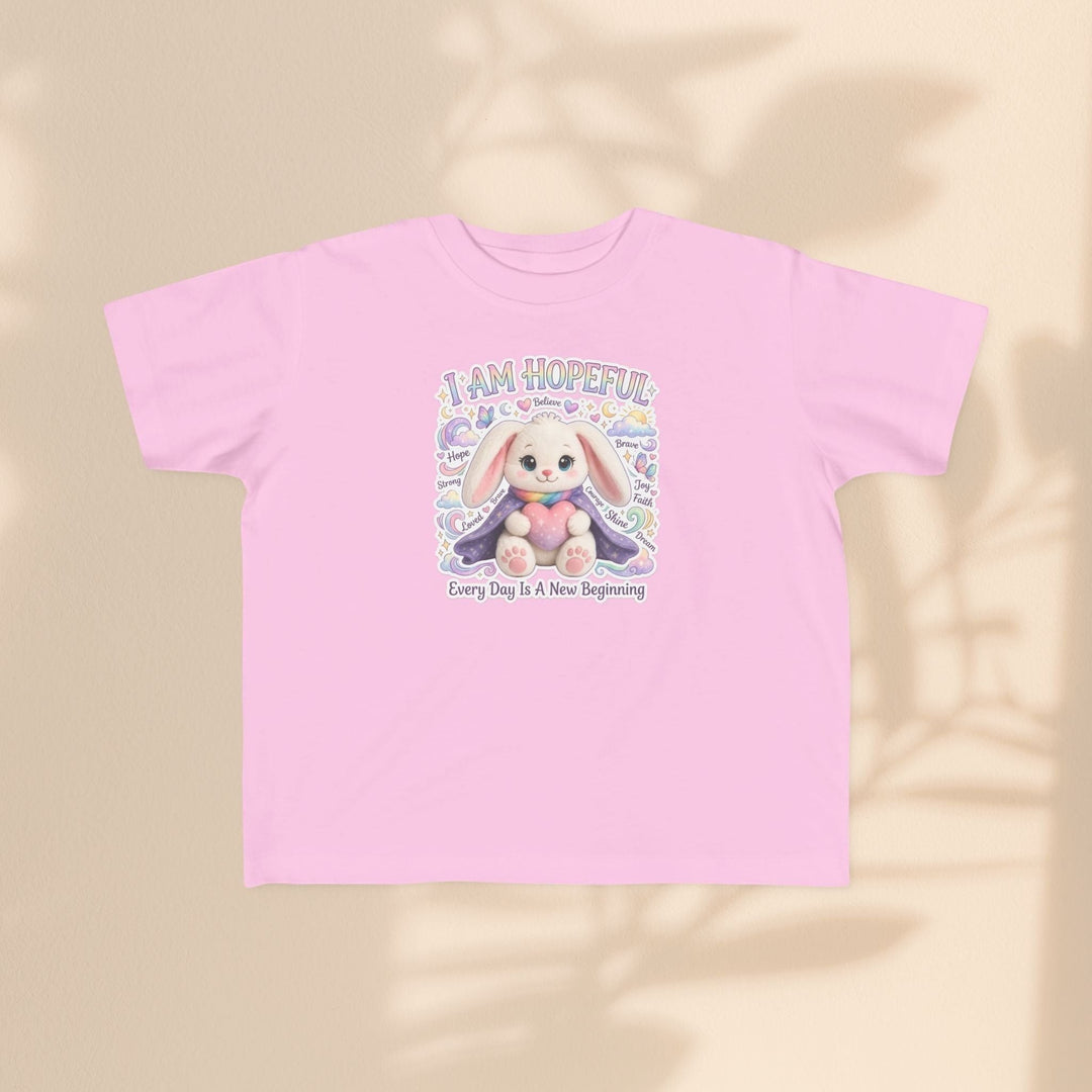 Sea Dragon Dreams toddler tee in light pink cotton featuring a cute Hope Bunny graphic with the text I Am Hopeful.