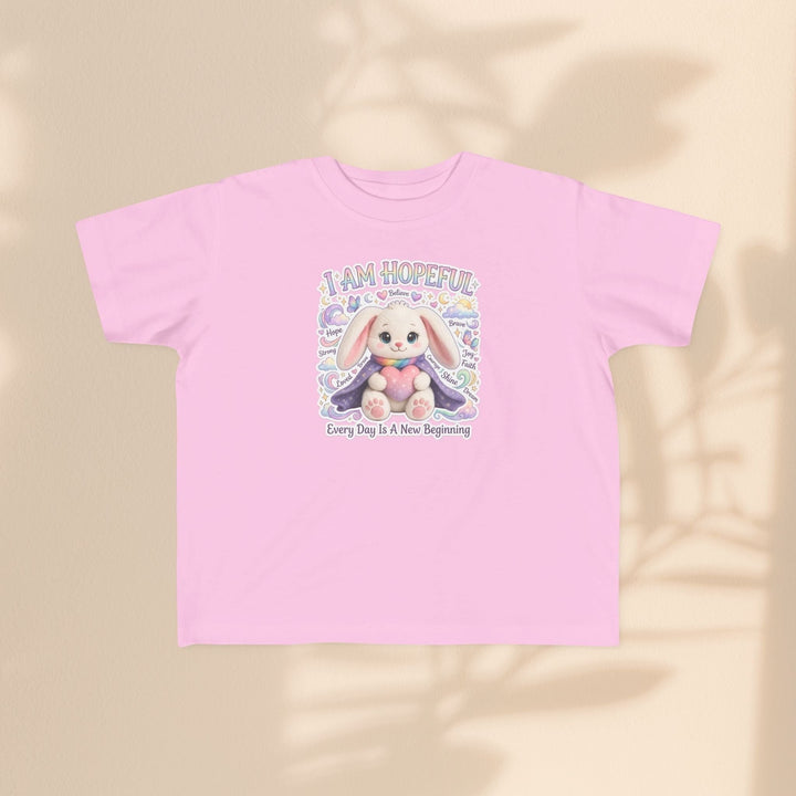 Sea Dragon Dreams toddler tee in light pink cotton featuring a cute Hope Bunny graphic with the text I Am Hopeful.