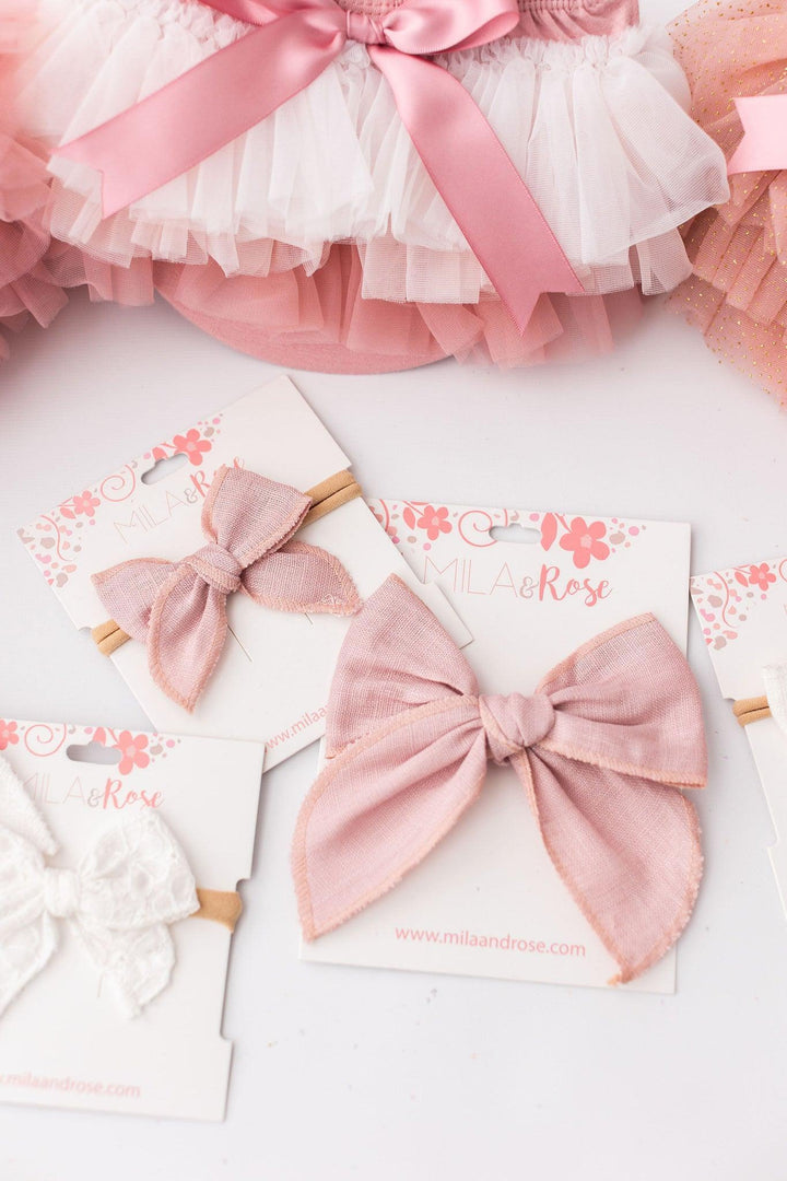 Sea Dragon Dreams vintage pink ombre ruffle tutu bloomer with matching linen-style hair bows on display cards.
