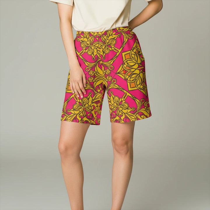 Sea Dragon Dreams women's bike shorts featuring a vibrant pink and yellow symmetrical floral print in a stretchy fabric.