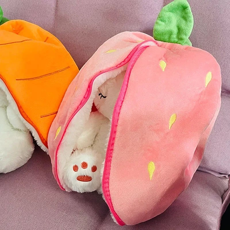 Sea Dragon Dreams plush bunny toy hiding inside a soft strawberry-shaped sleeping bag with a carrot pouch nearby