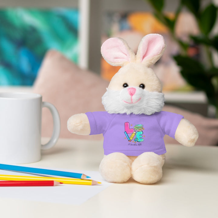 Sea Dragon Dreams 8-inch plush bunny wearing a purple cotton t-shirt with Love Teacher Life graphic on a desk