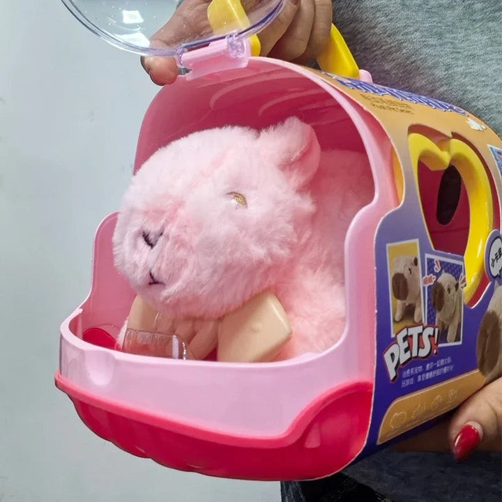 Sea Dragon Dreams electric plush capybara toy inside a pink plastic pet carrier with a clear lid