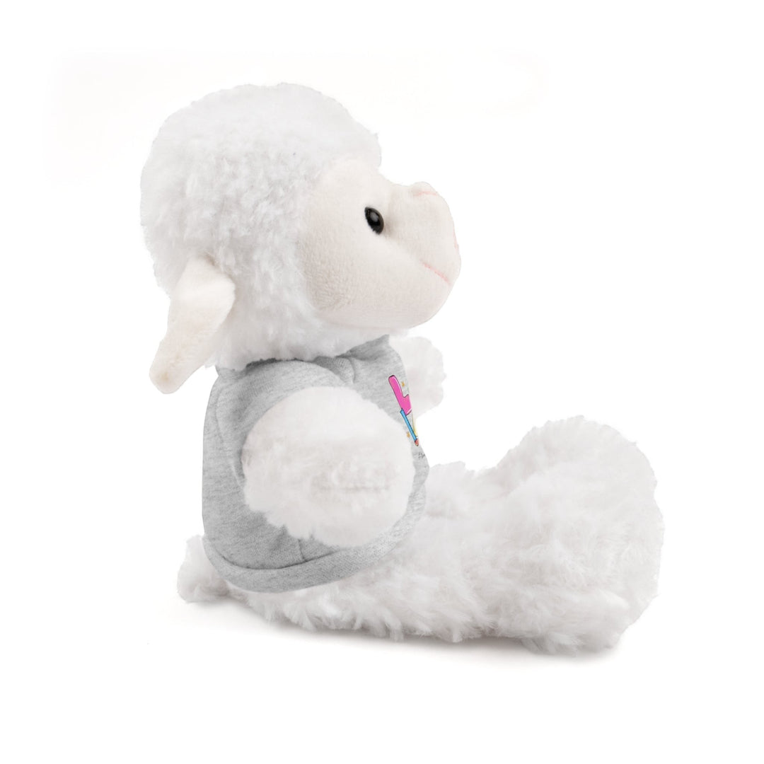 Sea Dragon Dreams white plush sheep stuffed animal wearing a grey cotton t-shirt, side view on white background.