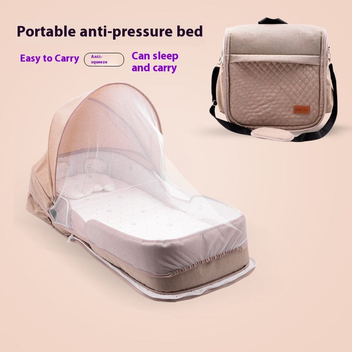 Sea Dragon Dreams portable baby lounger in beige with a protective mosquito net canopy and foldable travel bag design.