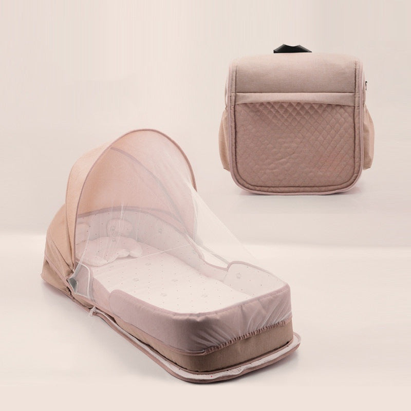 Sea Dragon Dreams portable baby lounger in beige with a protective mosquito net canopy and foldable travel design.